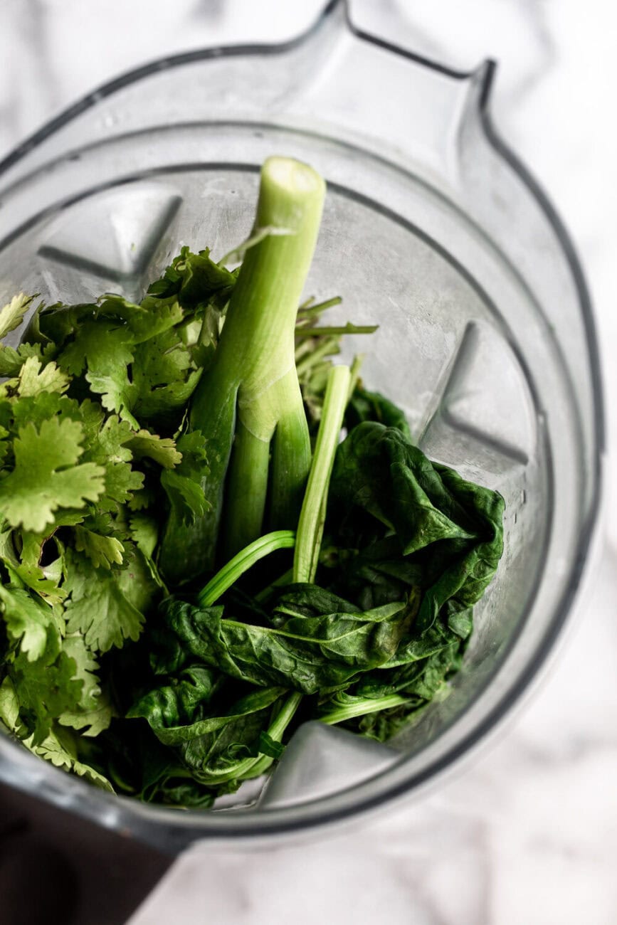 blender with spinach, green onion cilantro and serrano green sauce.