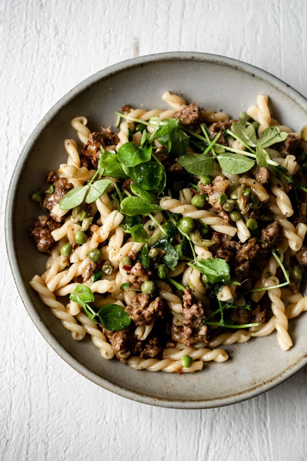 Spring Lamb Pasta with Peas and Greens American Lamb in stone bowl