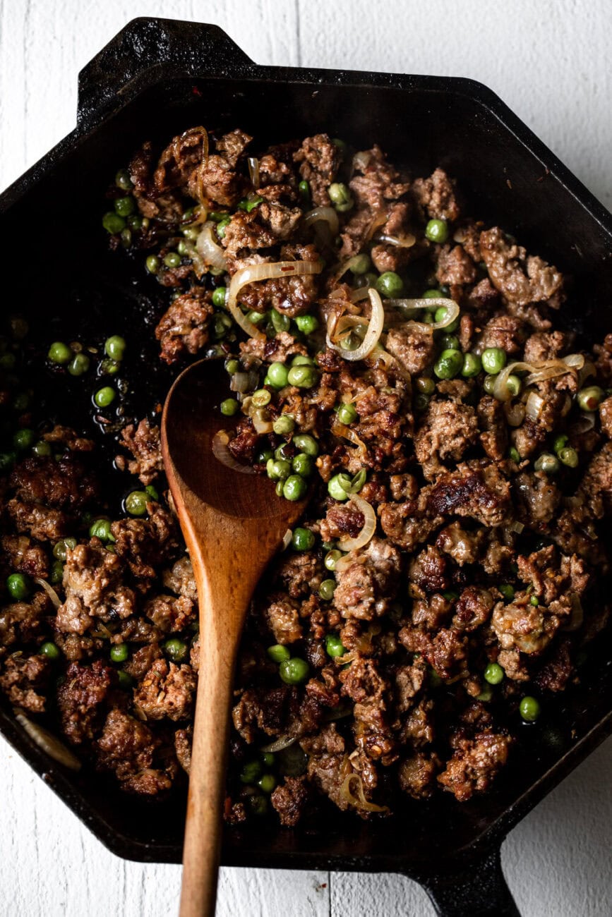 ground lamb sautéed in cast iron with peas and shallots.