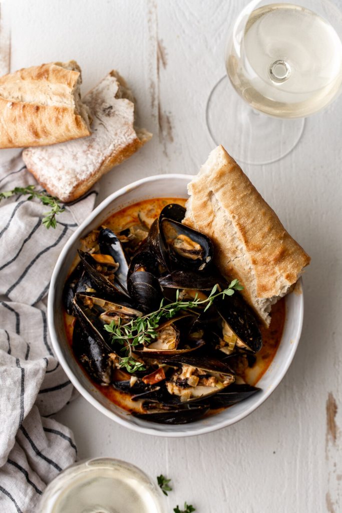 Steamed Mussels in Saffron Chorizo Broth in bowls