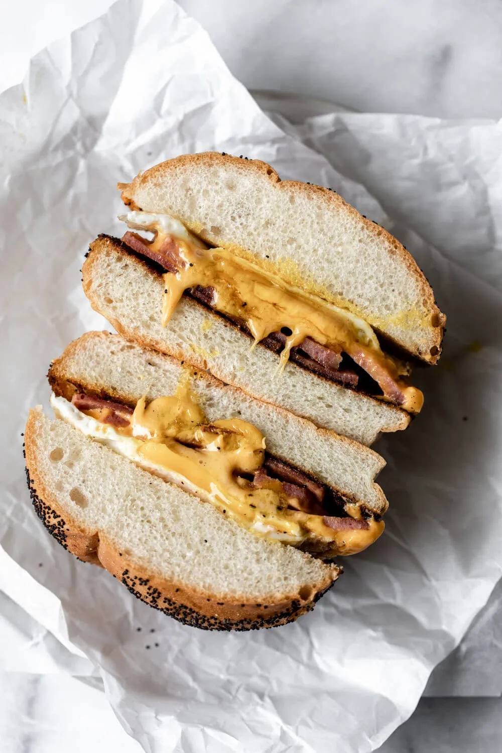 Taylor ham egg and cheese on kaiser roll halved with gooey egg