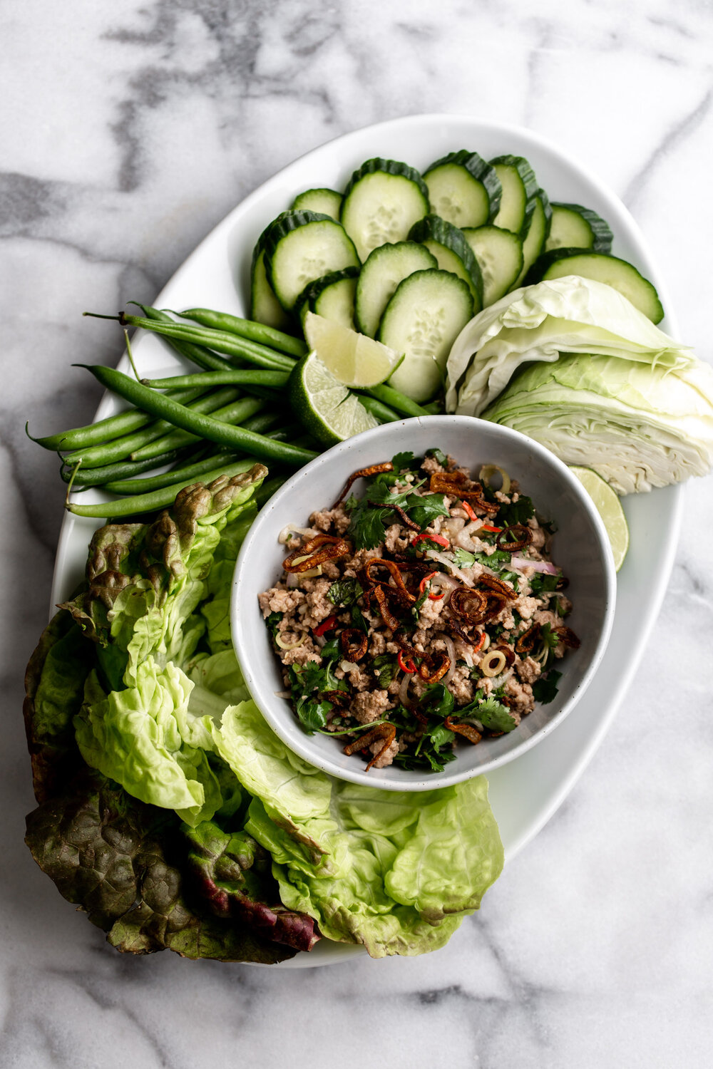 Thai Pork Larb recipe with cabbage wedges cucumber green beans 