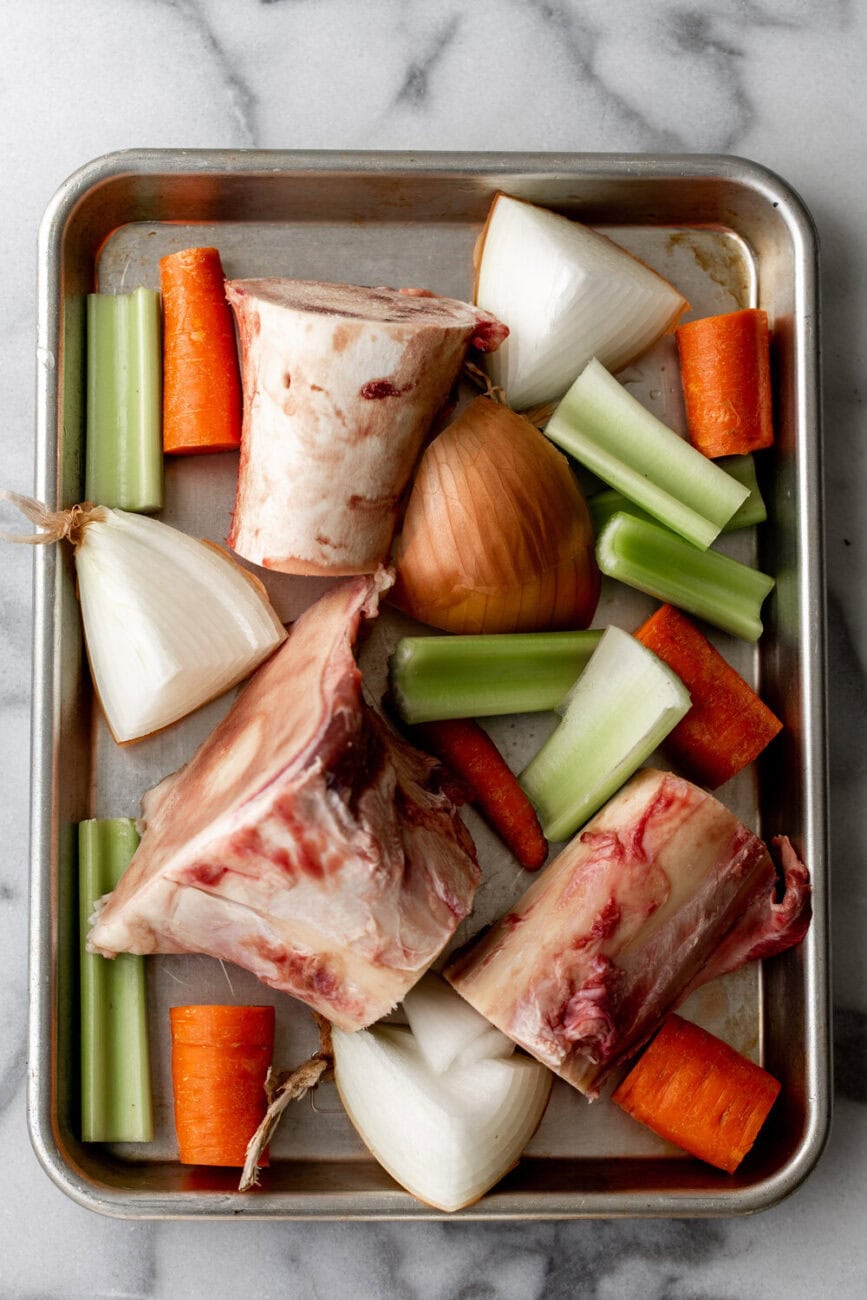 roasted bones and mirepoix on baking sheet.