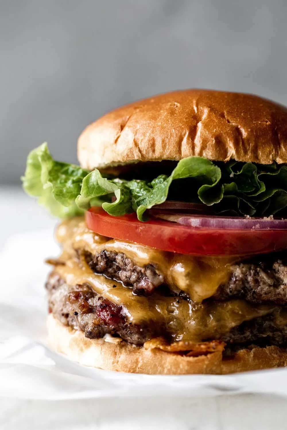 cheeseburger made with Bacon, Pork and Beef on buns