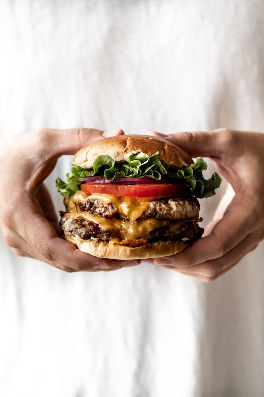 Triple Play Burger with Bacon, Pork and Beef tomato lettuce and red onion.