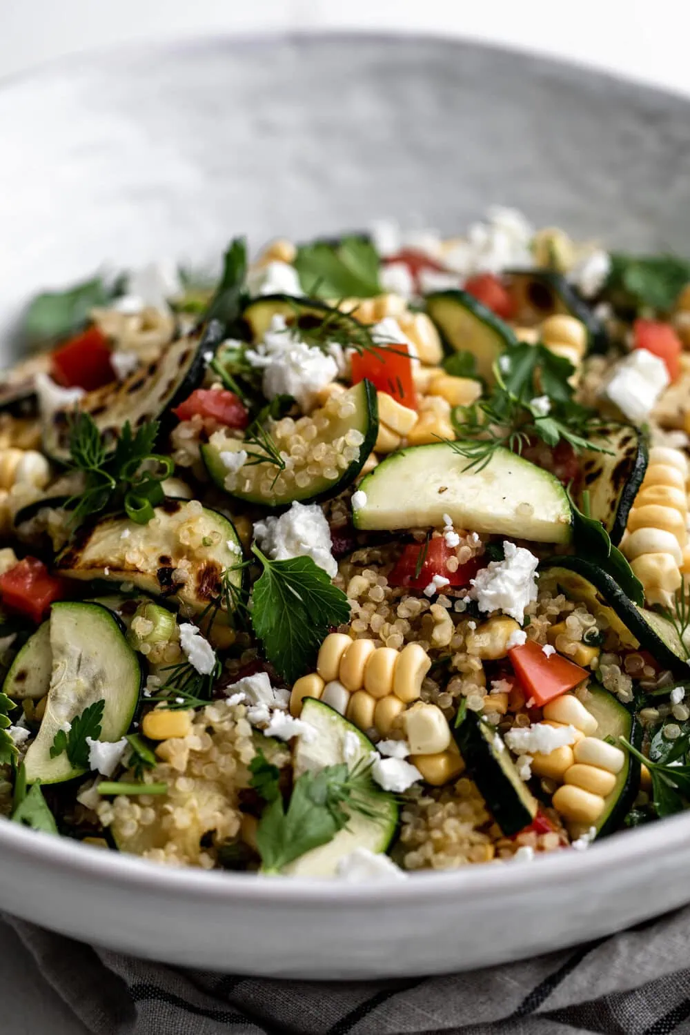Vegetable Quinoa Salad with Honey Lemon Vinaigrette in white bowl