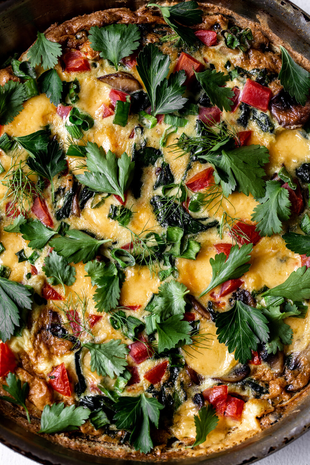 Veggie Fritatta with roma tomato mushrooms cheddar cheese and fresh herbs