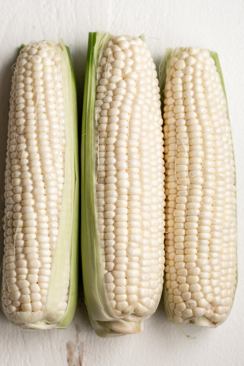 three ears of corn shucked