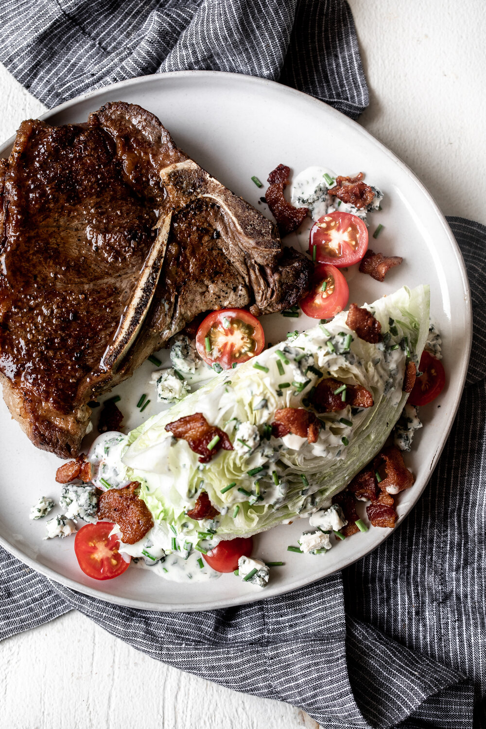 This retro/classic wedge salad recipe with iceberg lettuce bacon tomatoes and herb buttermilk dressing