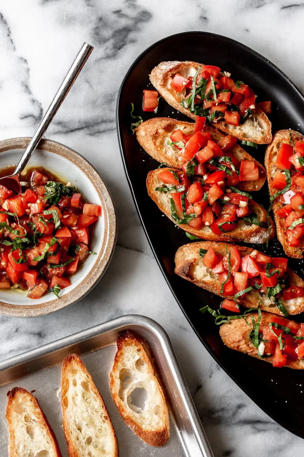 bruchetta served over crostini with diced basil and tomatoes