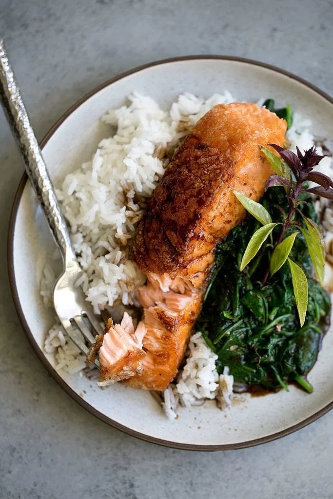 Crispy Salmon with Soy Tamarind Sauce over Sautéed Spinach