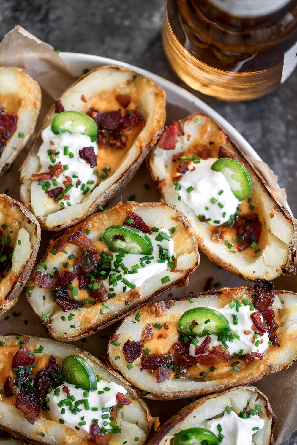 halved cheesy game day potato skins with cheddar, bacon sour cream 