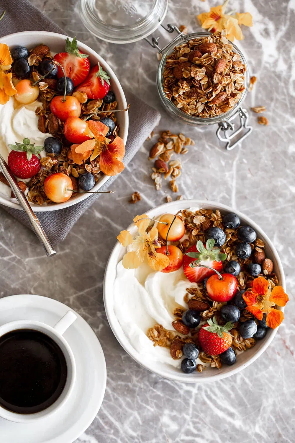 Homemade honey almond granola made with old fashioned oats honey brown sugar and almonds over yogurt