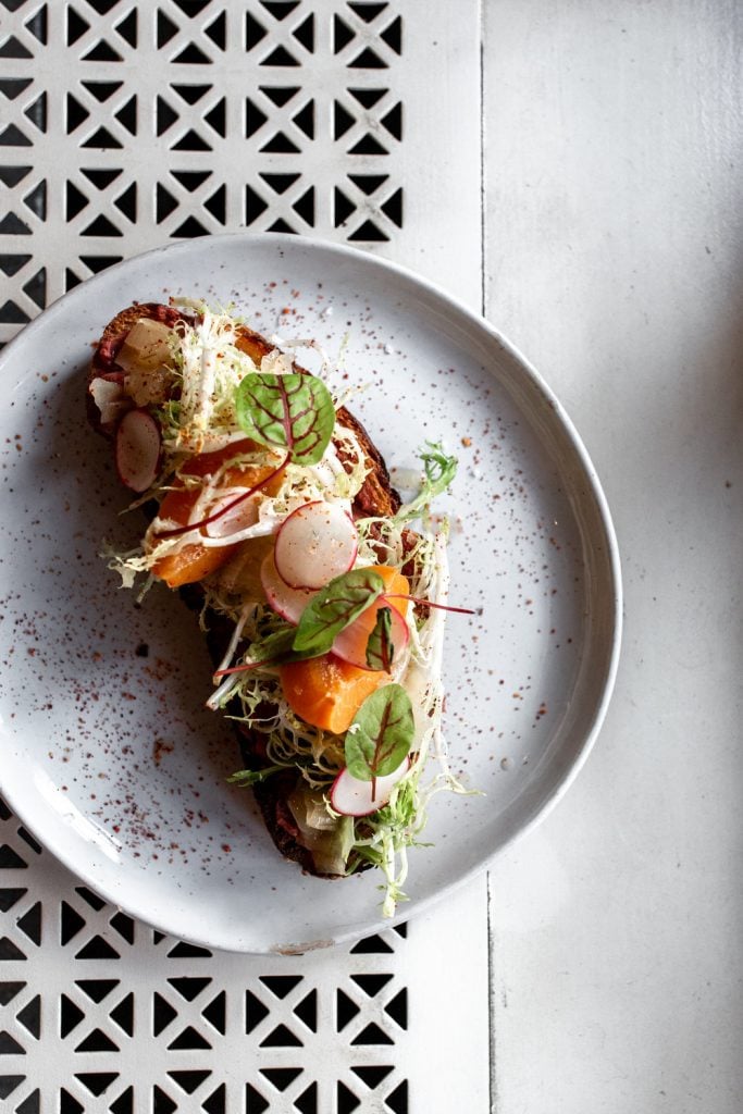 toast with shaved radish and frisee.