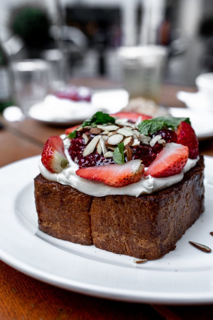 large piece french toast with cream and berries.