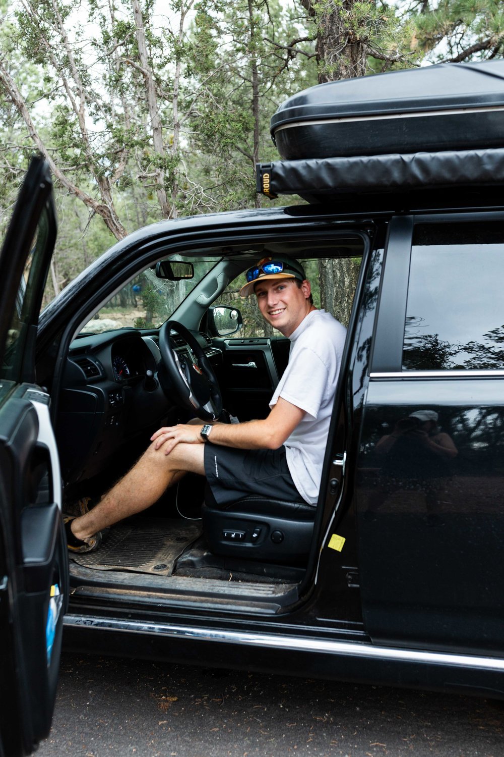 josh in toyota 4runner cooking with cocktail rings camping