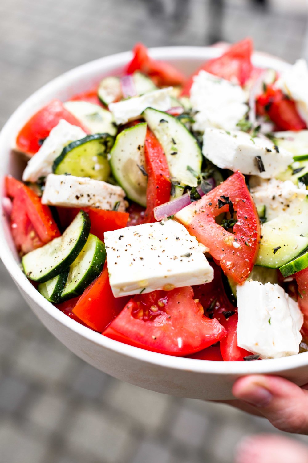 closeup greek salad cooking with cocktail rings