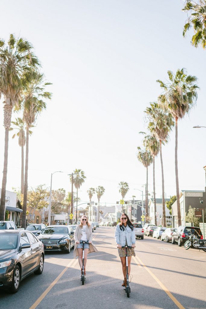 two women using bird scooter in Westside of Los Angeles