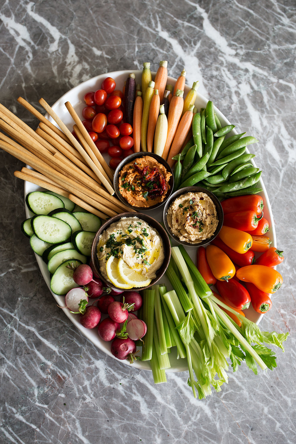 Mediterranean Crudités Platter with hummus sweet peppers radish celery breadsticks peas carrots and cucumber