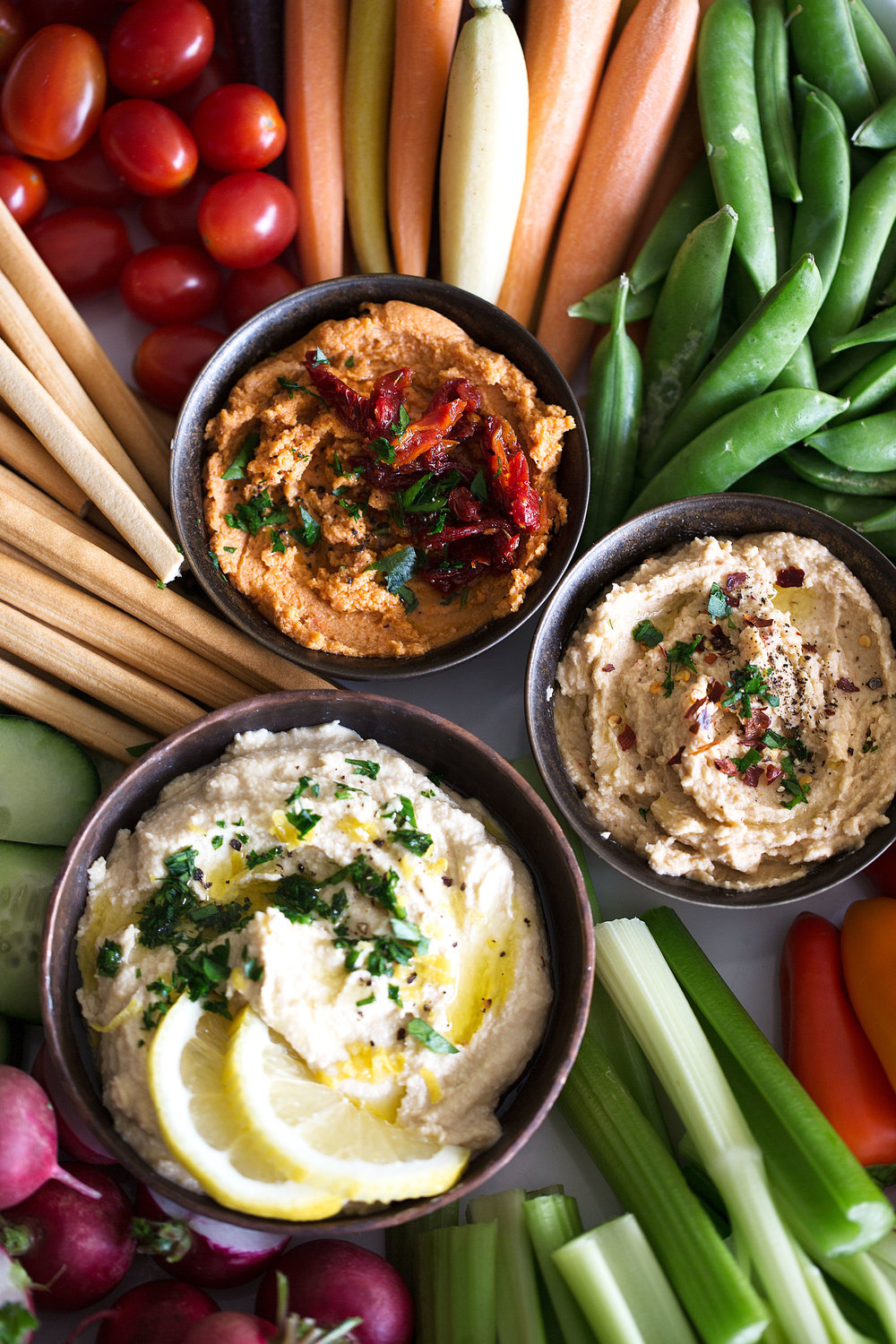 hummus trio closeup lemon jummus garlic hummus and spicy hummus