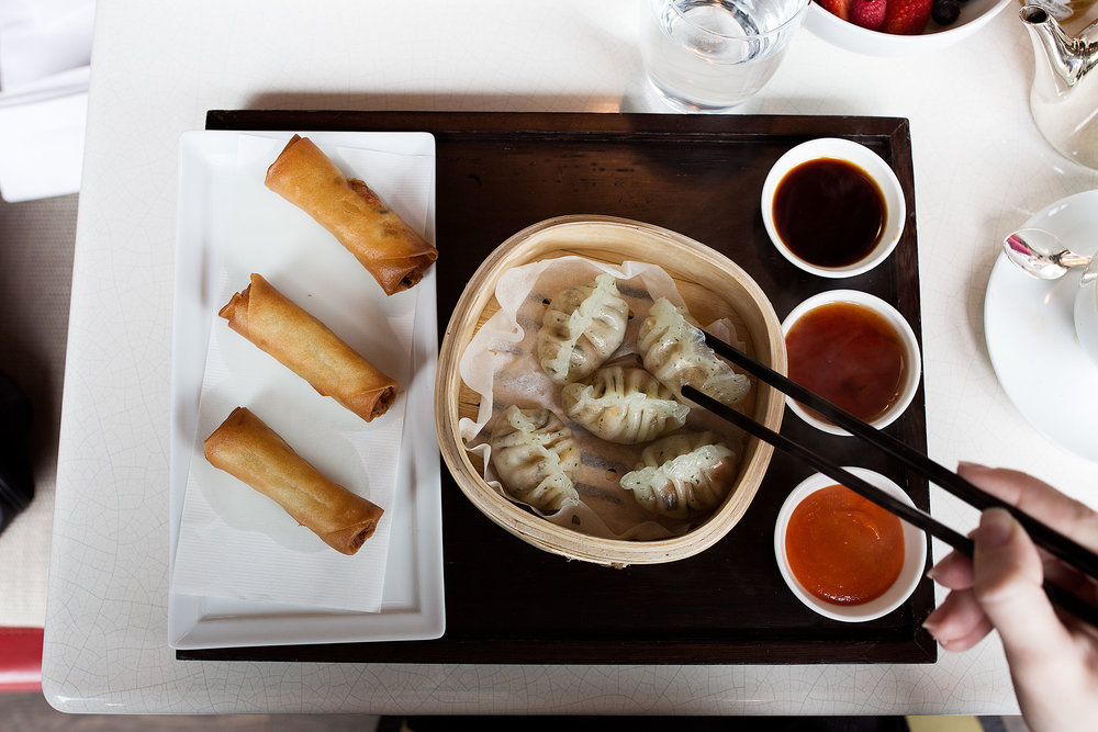 dumplings and egg rolls on tray