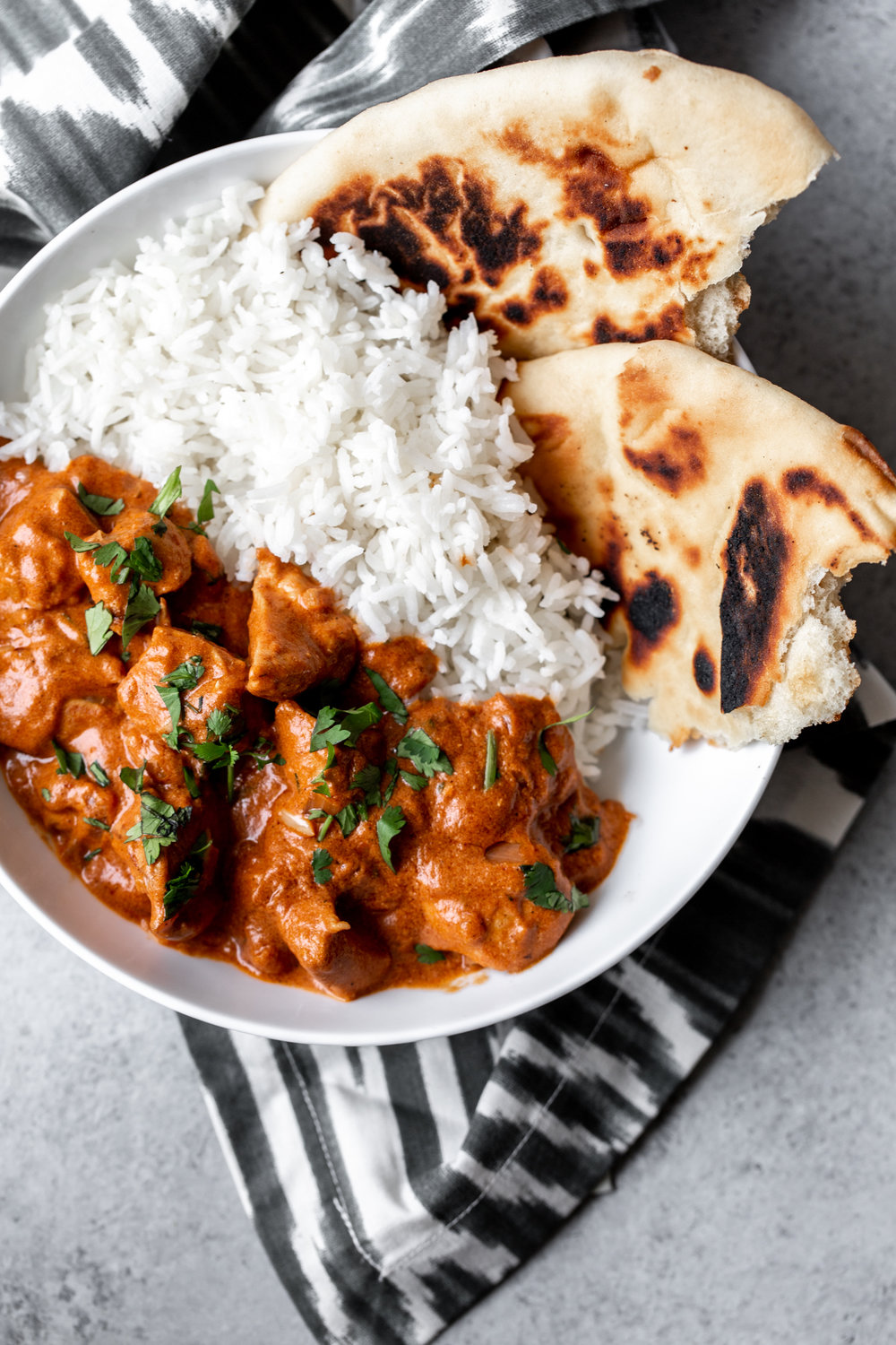 Indian butter chicken made with chicken breast simmered in a fragrant spiced tomato base finished with creamy yogurt and served with rice.