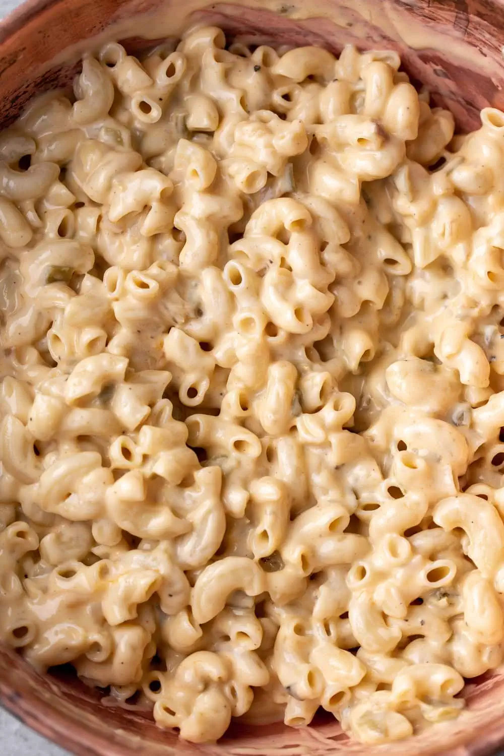 green chili skillet mac and cheese in cheese sauce with elbow macaroni