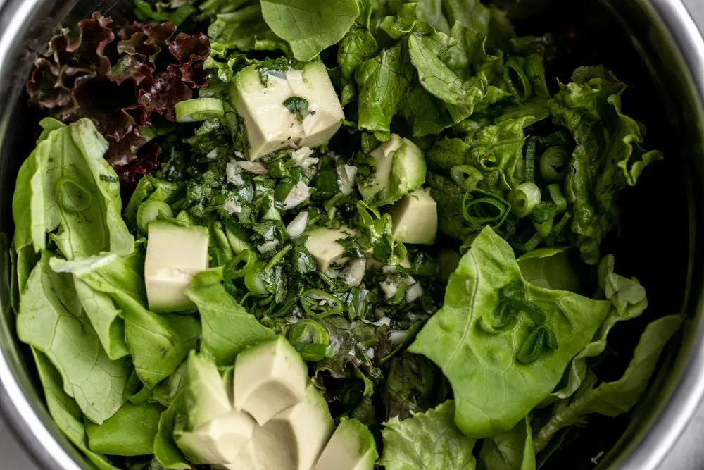 butter lettuce salad with cilantro lime dressing ingredients in mixing bowl