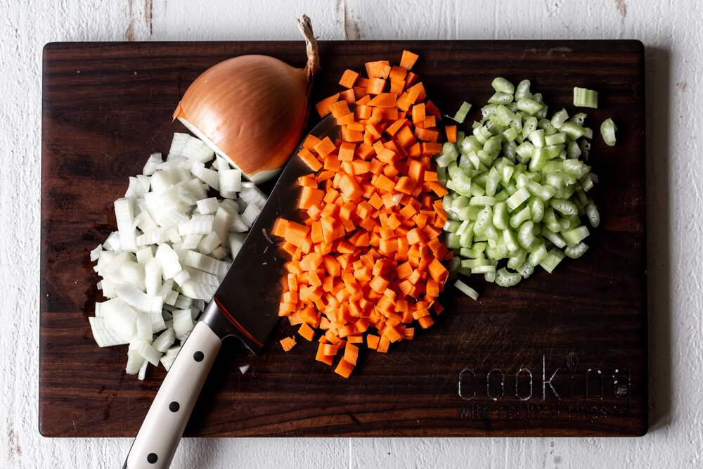 diced mirepoix on cutting board carrots celery and onion