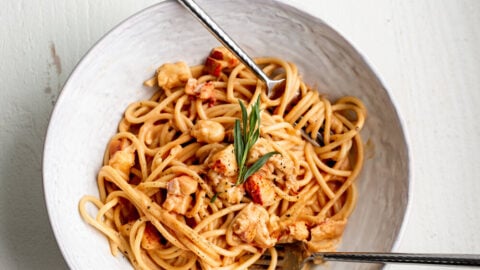 creamy lobster pasta made with bucatini garnished with tarragon.