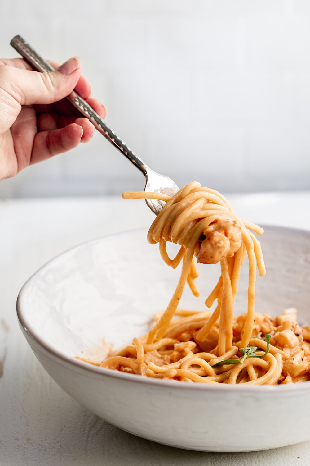 creamy lobster pasta with noodle pull on fork