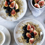 Coconut quinoa oatmeal with maple syrup. Garnished with fruit.