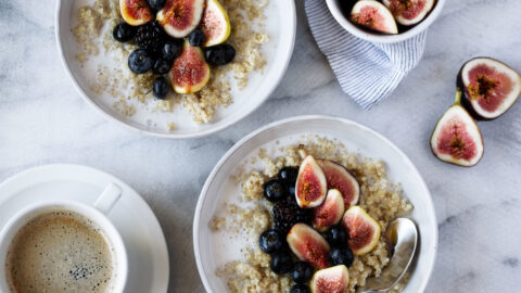 Coconut quinoa oatmeal with maple syrup. Garnished with fruit.