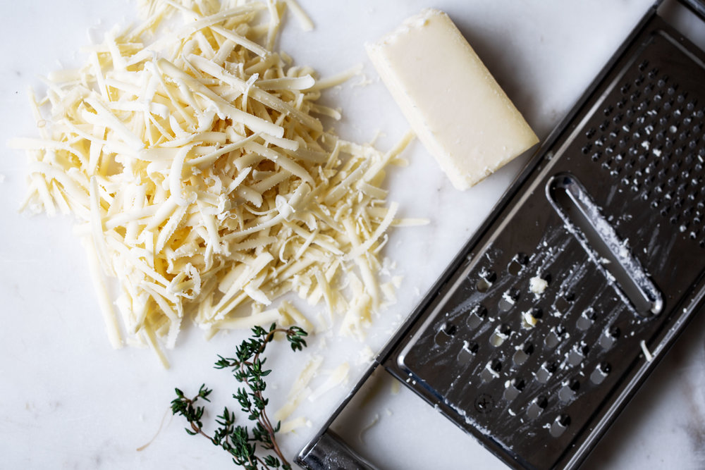 gruyere cheese shredded for french onion soup with cheese grater
