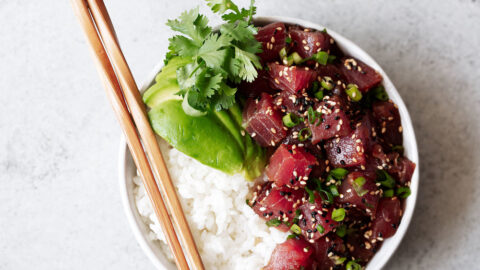 Hawaiian Ahi Tuna Poke recipe with avocado over white rice with chopsticks.