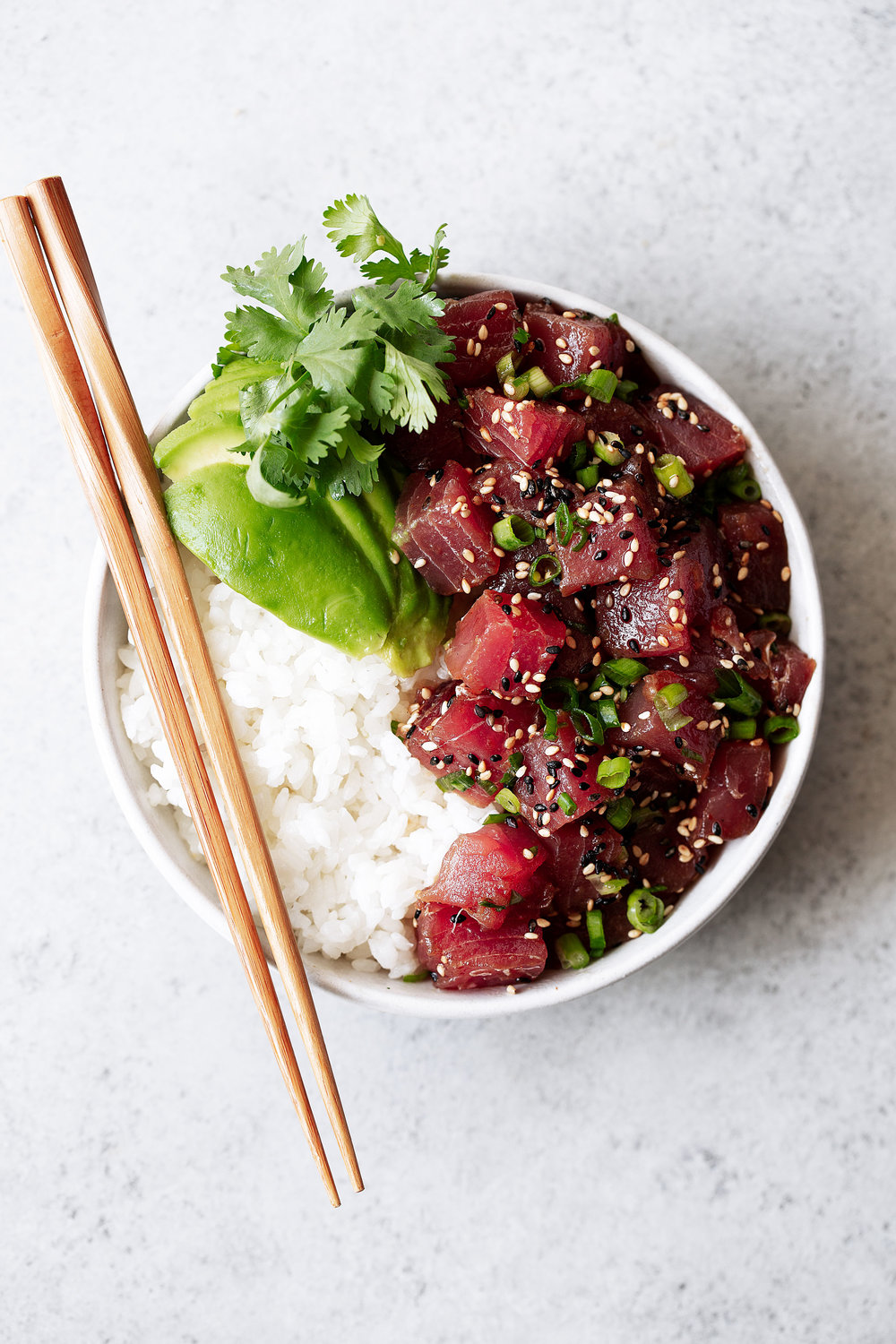 Hawaiian Ahi Tuna Poke recipe with avocado over white rice with chopsticks