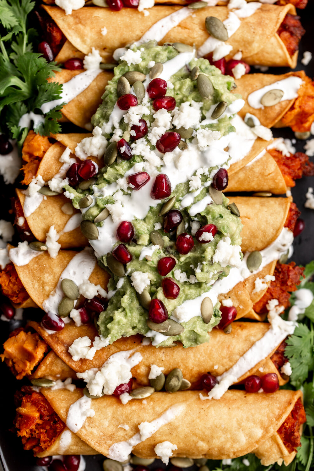 sweet potato taquitos with guacamole and sour cream