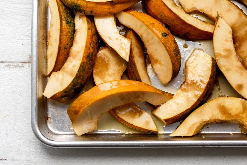 acorn squash ingredient shot on baking sheet