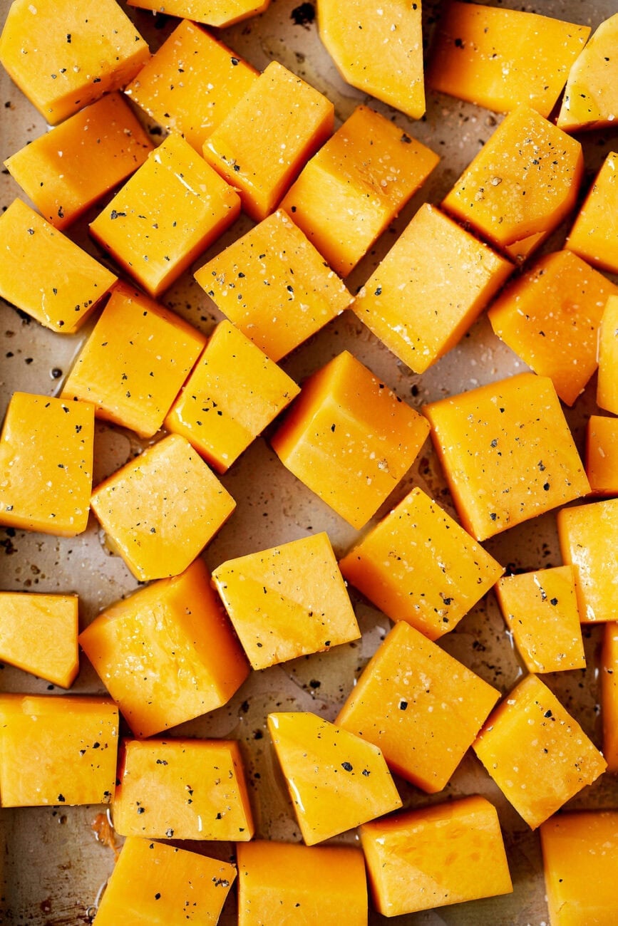 diced butternut squash on baking sheet in olive oil.