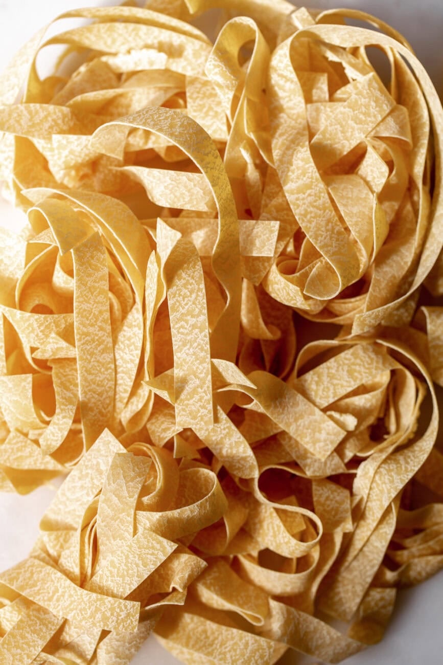 Pappardelle pasta noodles to be cooked for pasta.