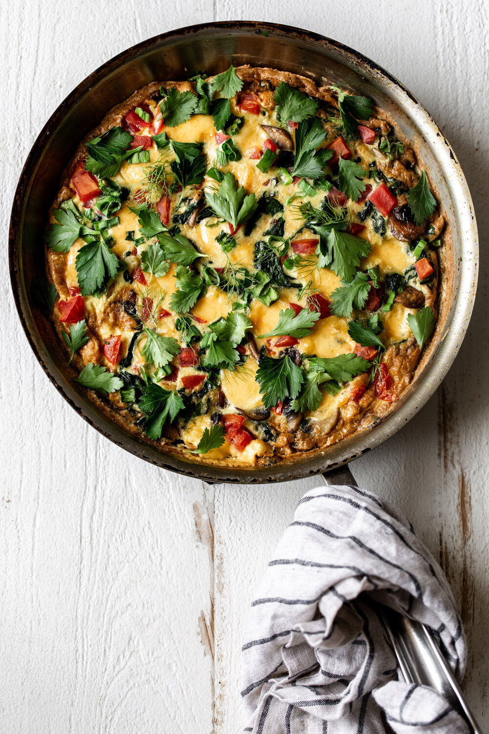 Veggie Fritatta in pan with fresh herbs