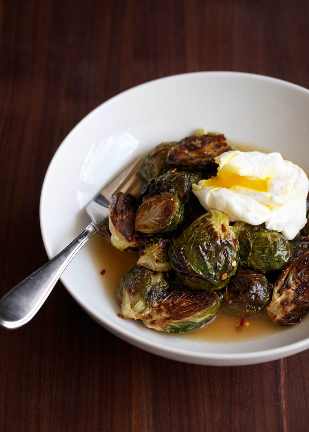 crispy brussels sprouts with bacon dashi broth and poached egg on top
