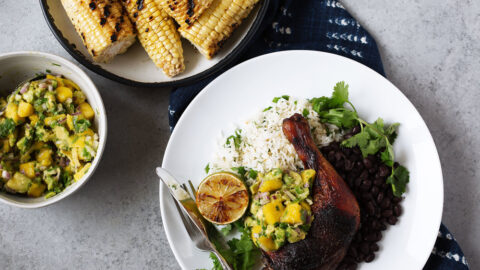 Roast jerk chicken with mango avocado salsa over white rice and black beans.