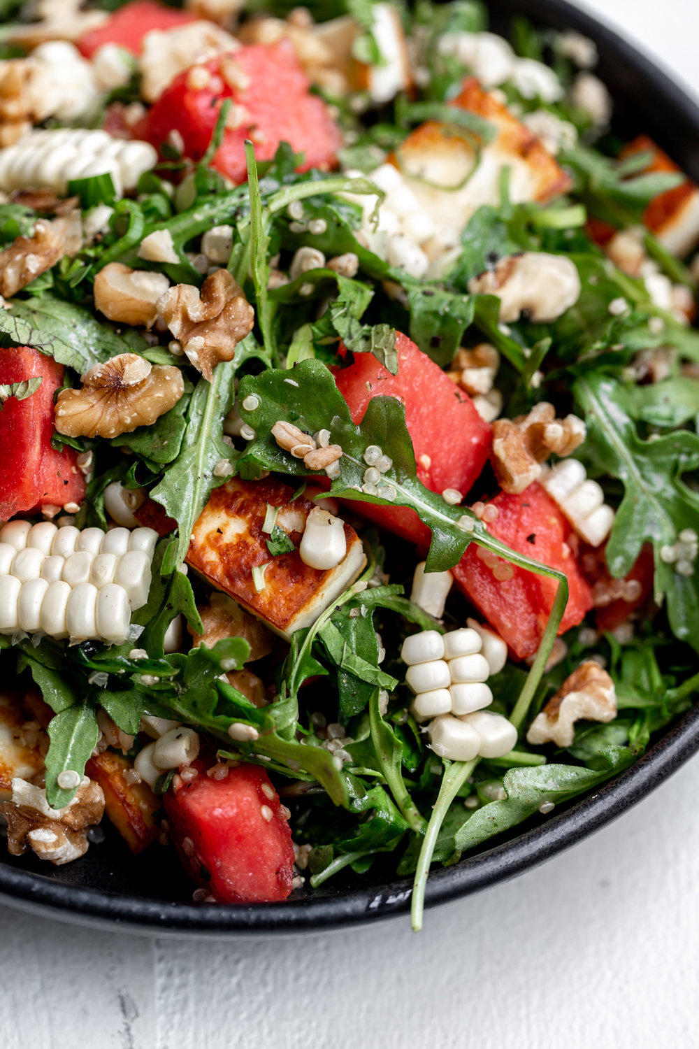 watermelon salad with grilled halloumi cheese recipe topped with corn and walnuts with farro and quinoa