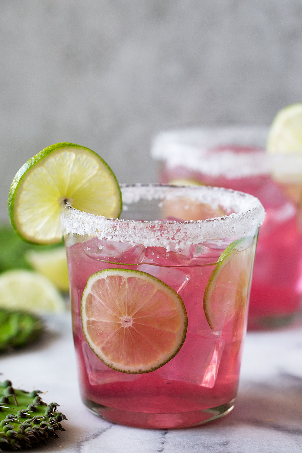 prickly pear margarita with salt rim and lime slices