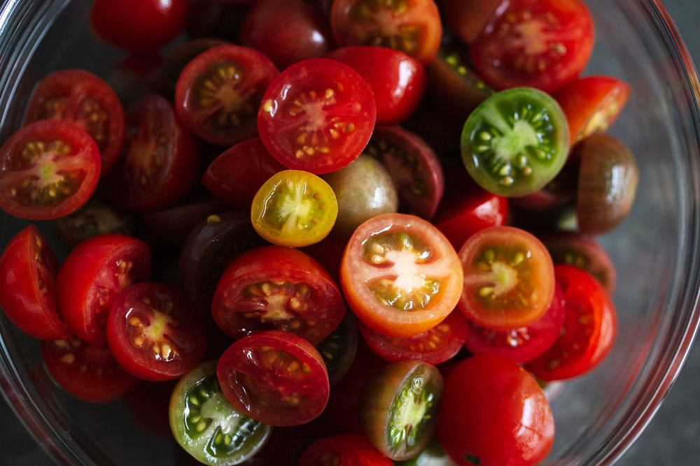 halved cherry tomatoes in bowl