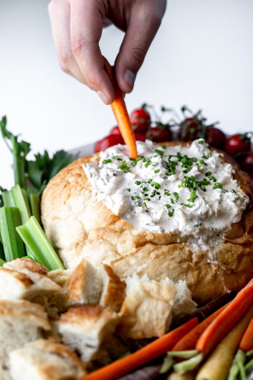 crab dip in a bread bowl cooking with cocktail rings carrot.
