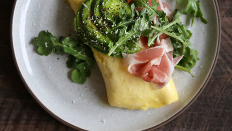 French Omelette with Prosciutto slices, Cheese Avocado & Arugula.