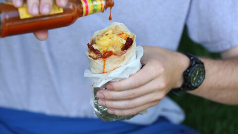 lily's california breakfast burrito with refried beans and cheese bacon and scrambled eggs in flour tortilla.