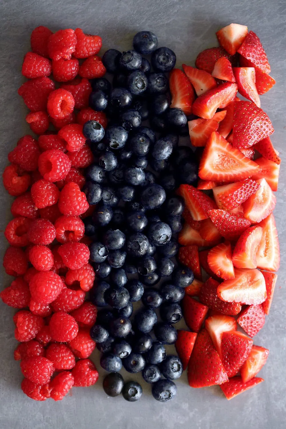strawberries, raspberries and blueberries in lines